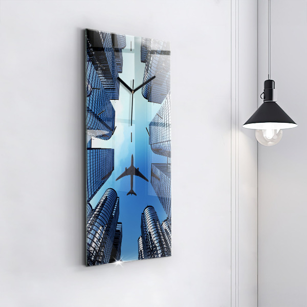 Reloj de vidrio vertical Avión sobre edificios - espejomat.es