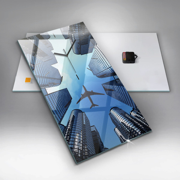 Reloj de vidrio vertical Avión sobre edificios - espejomat.es