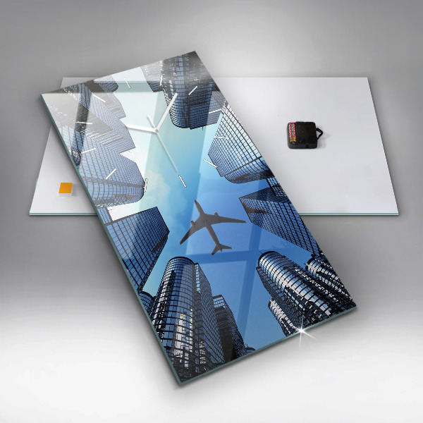 Reloj de vidrio vertical Avión sobre edificios - espejomat.es