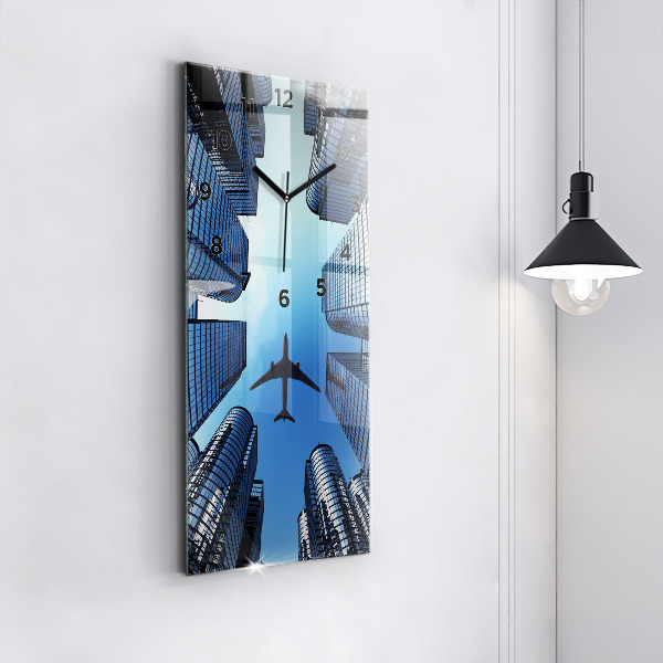 Reloj de vidrio vertical Avión sobre edificios - espejomat.es